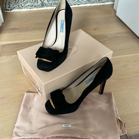 Prada Shoes - Prada black suede heels with black bow and gold detail. 5 inch heel.
